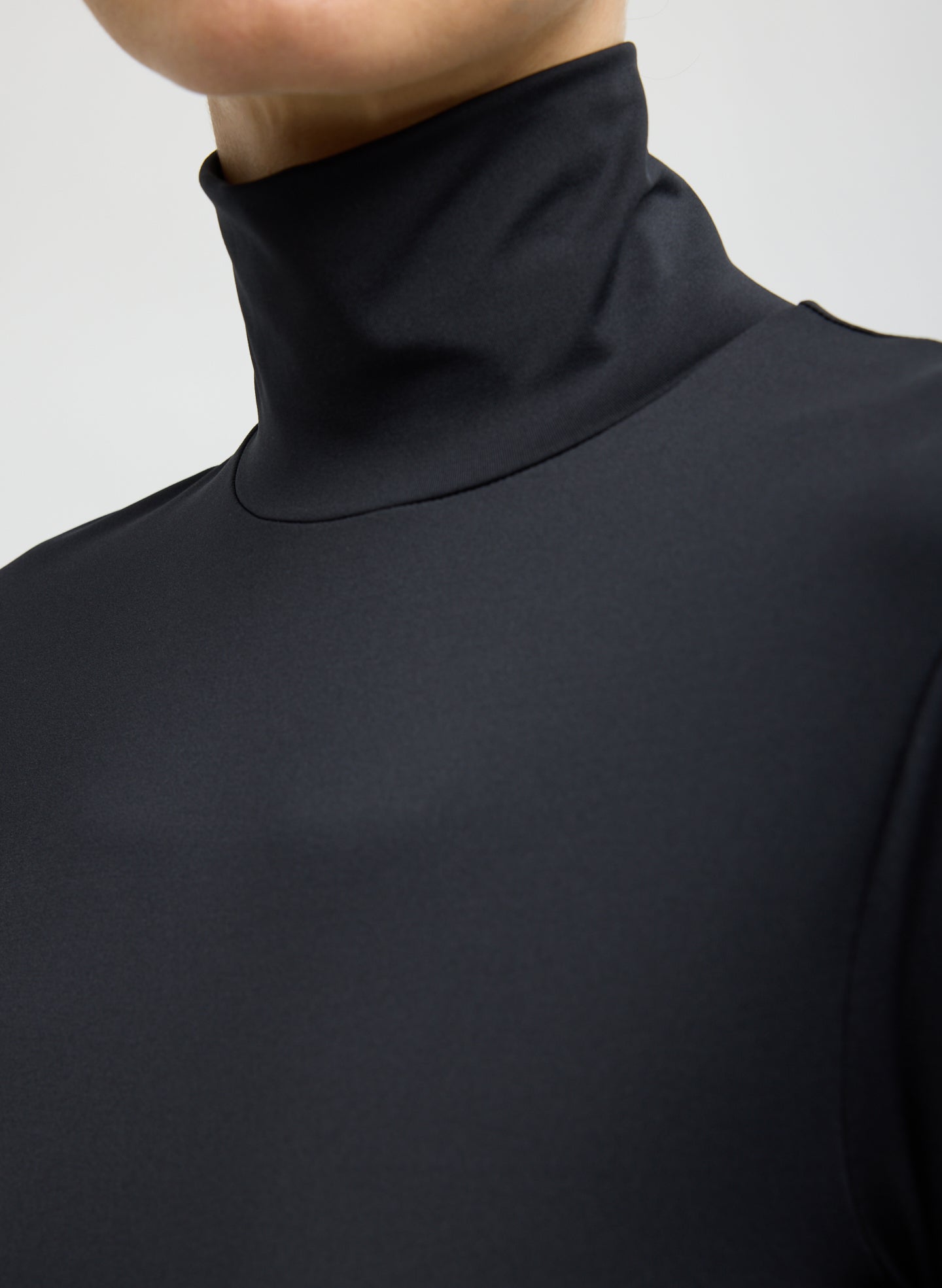 Black Stretch Light Weight Tech Knit Turtleneck - closeup of turtleneck