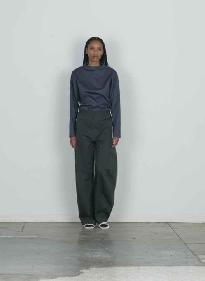 Model wearing the chino sid pant - petite grey walking forward and turning around