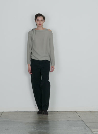 Model wearing the feather weight eco crepe benedict top grey walking forward and turning around