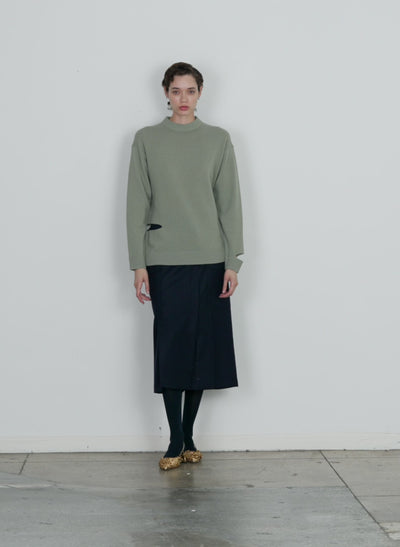 Model wearing the soft lambswool crewneck easy pullover pale olive walking forward and turning around