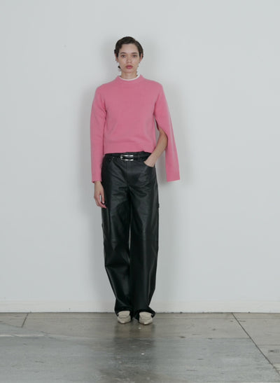 Model wearing the soft lambswool shrunken crewneck pullover pink walking forward and turning around