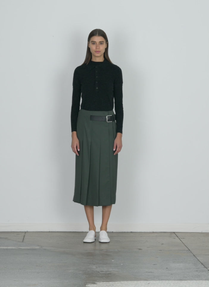 Model wearing the grain de poudre wide pleat wrap skirt grey pine walking forward and turning around