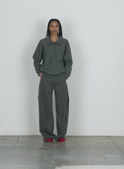 Model wearing the sweatshirt winslow pant - regular grey pine walking forward and turning around