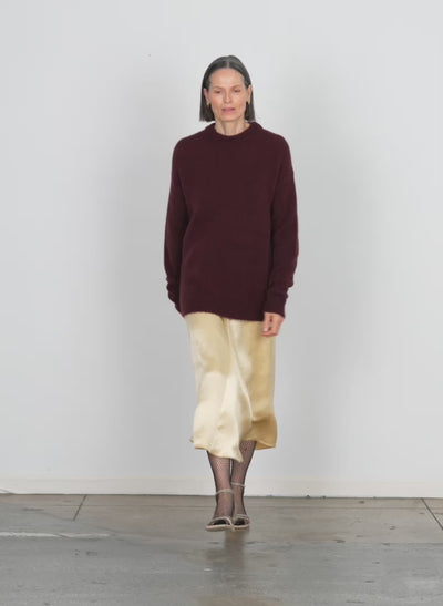 Model wearing the soft mohair crewneck easy pullover with slit cuffs garnet walking forward and turning around