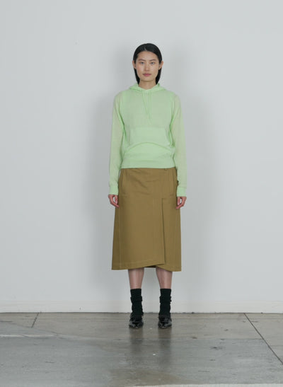 Model wearing the skinlike mercerized wool shrunken hoodie pale lime walking forward and turning around