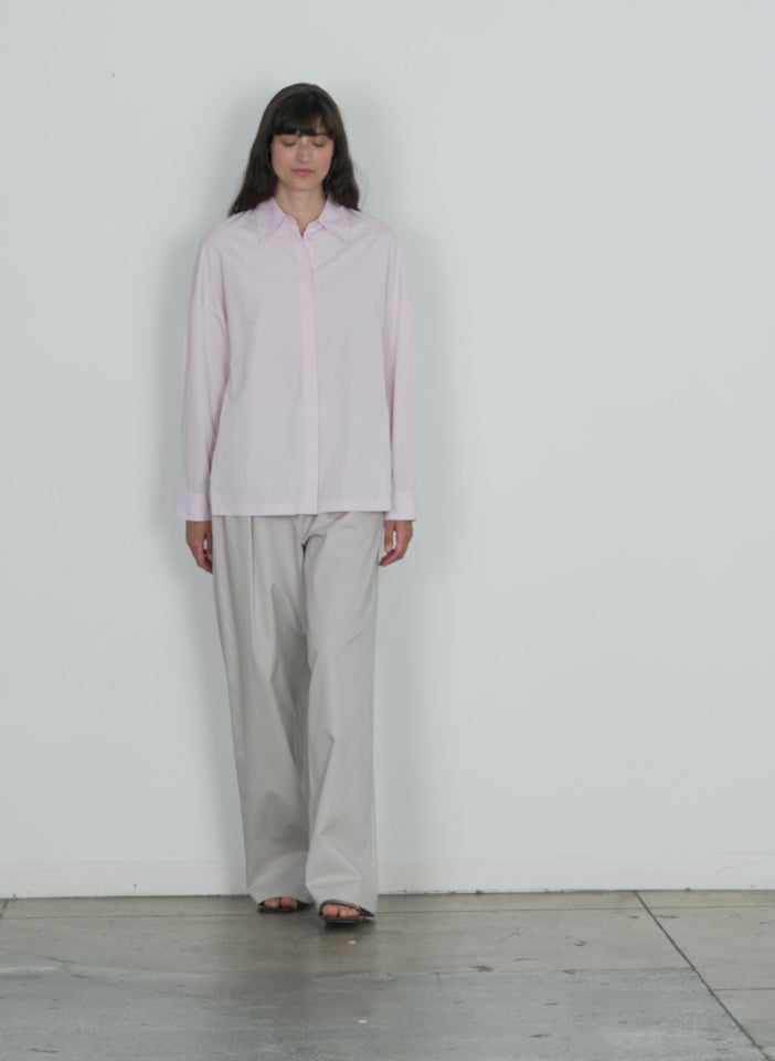 Model wearing the shirting gabe oversized shirt pink walking forward and turning around