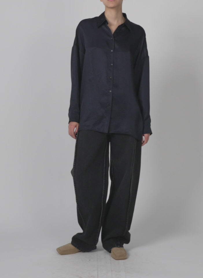 Model wearing the spring acetate shirt w cocoon back dark navy walking forward and turning around