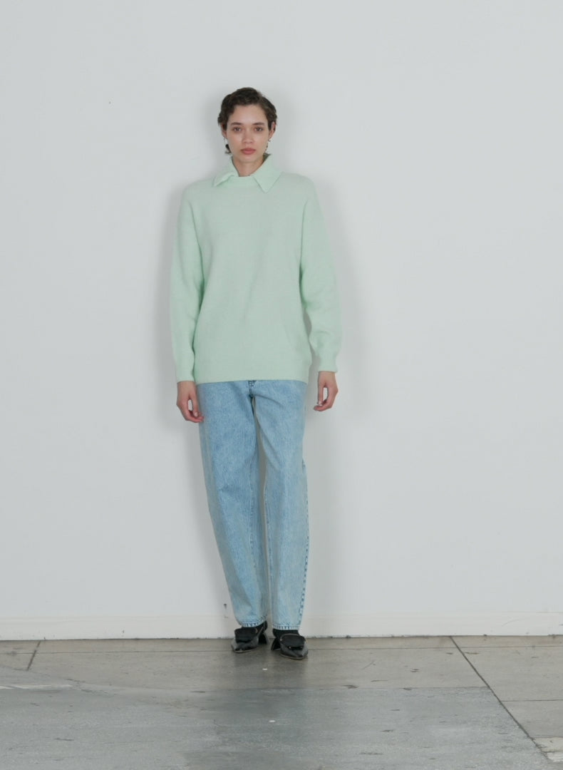 Model wearing the douillet crewneck easy pullover pale mint walking forward and turning around