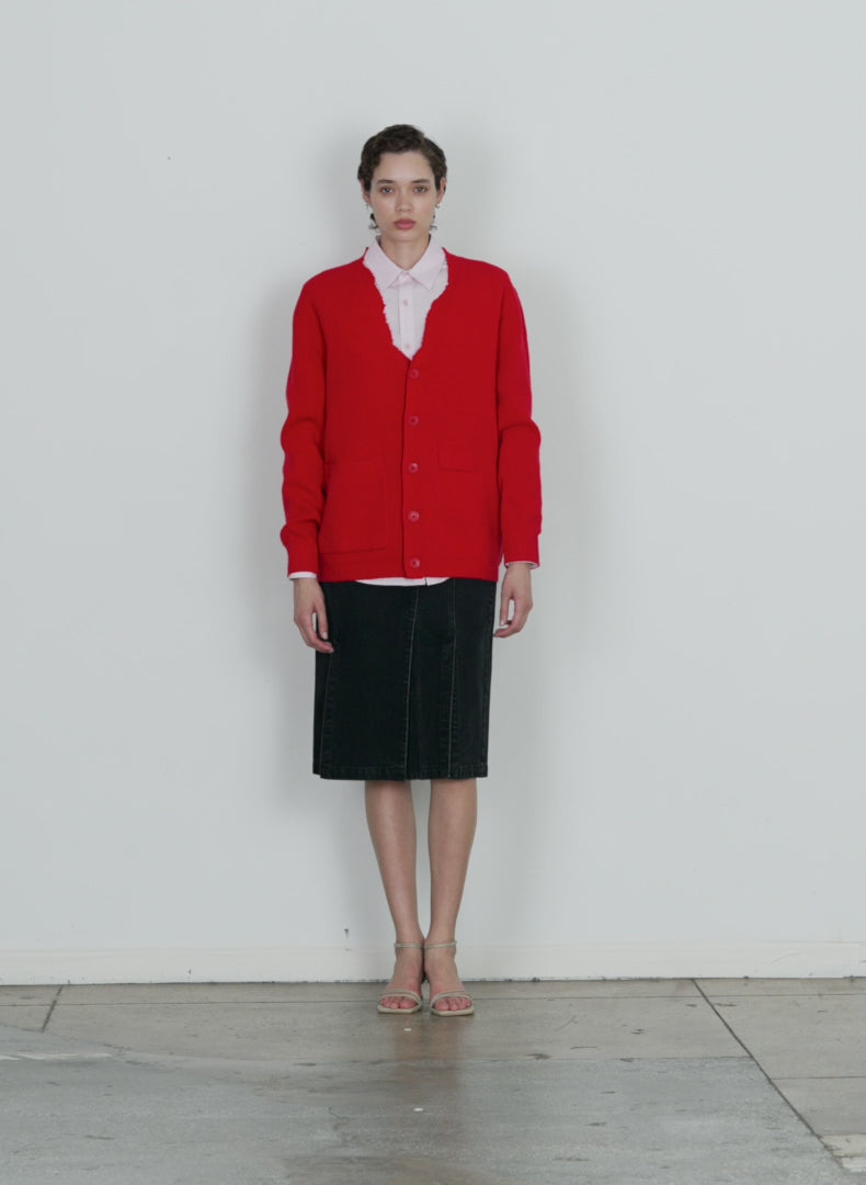 Model wearing the soft lambswool distressed cardigan red walking forward and turning around