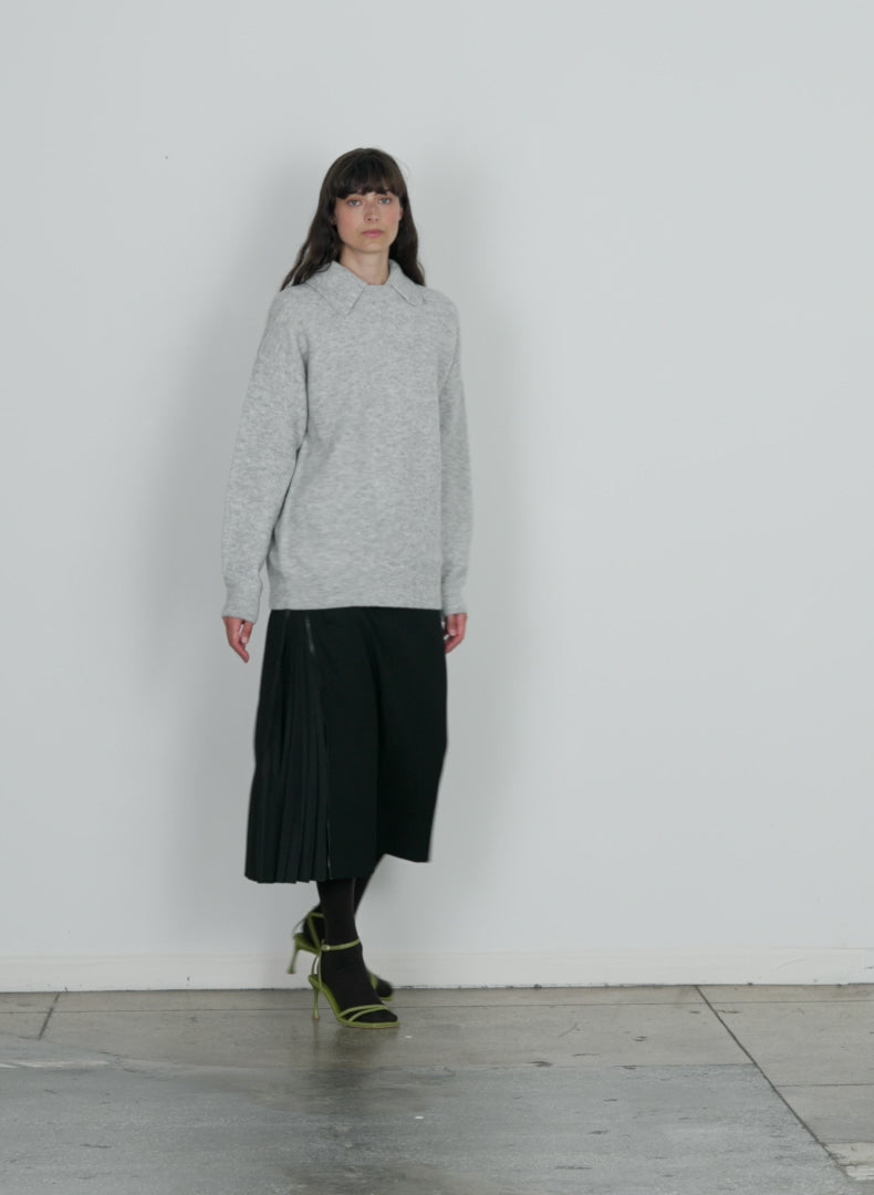 Model wearing the douillet crewneck easy pullover light heather grey walking forward and turning around