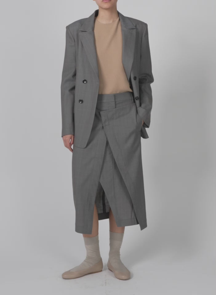 Model wearing the grant crossdye suiting wrap trouser skirt grey multi walking forward and turning around