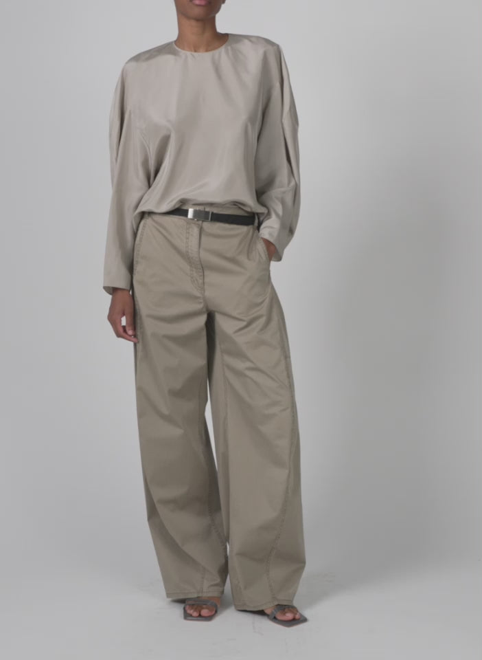 Model wearing the garment dyed silky cotton sid chino pant acorn walking forward and turning around