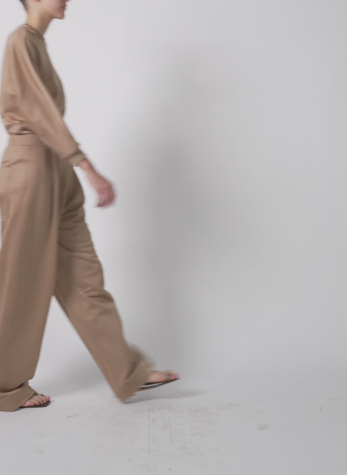 Model wearing the silk terry sculpted sleeve slim sweatshirt granola walking forward and turning around