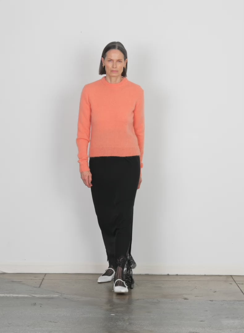 Model wearing the soft mohair shrunken crewneck pullover imperial topaz walking forward and turning around