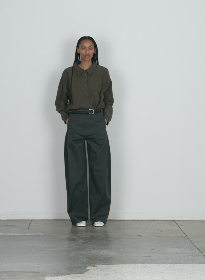 Model wearing the chino sid pant - regular grey walking forward and turning around