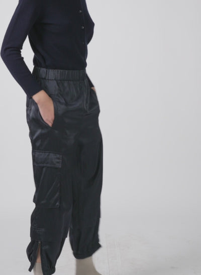 Model wearing the shiny nylon wilt pull on jogger navy 1 walking forward and turning around