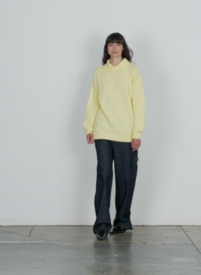 Model wearing the douillet crewneck easy pullover yellow walking forward and turning around