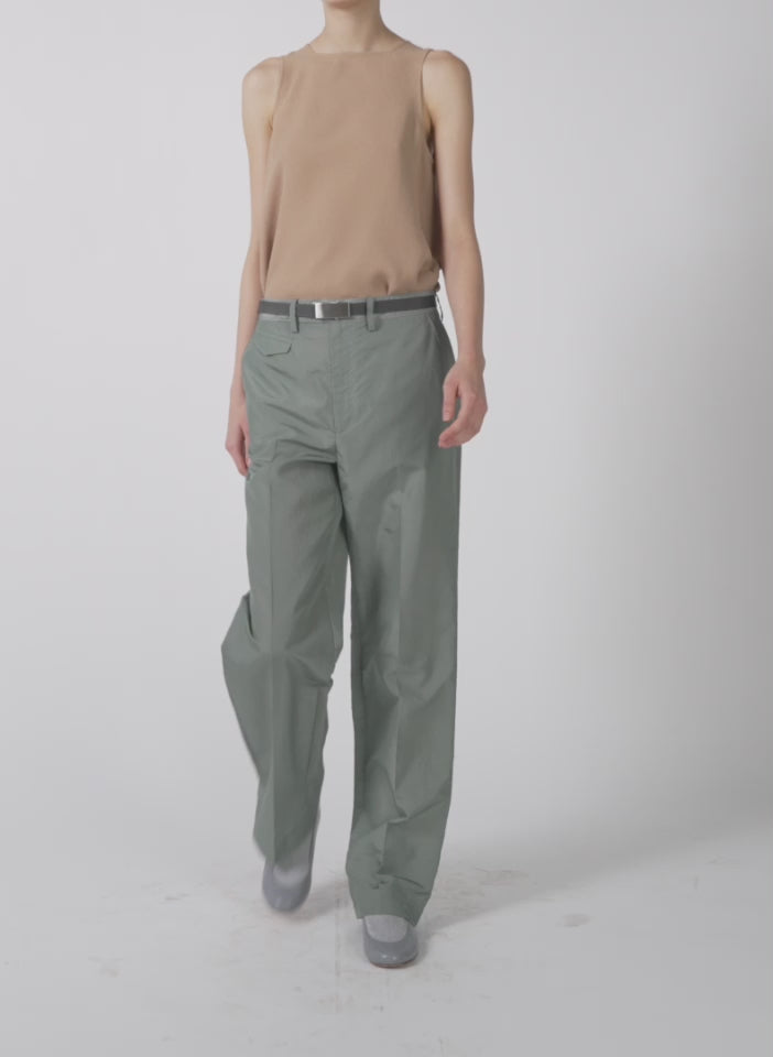 Model wearing the silk nylon straight leg trouser pumice grey walking forward and turning around