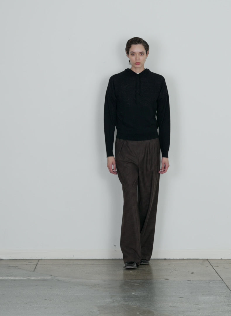 Model wearing the jett suiting asymmetrical pleat stella pant brown multi walking forward and turning around