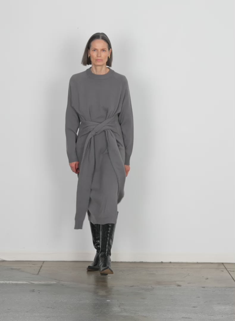 Model wearing the airy extrafine wool blair dress grey walking forward and turning around