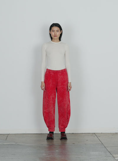 Model wearing the acid wash sweatshirt program calder sweatpant red multi walking forward and turning around