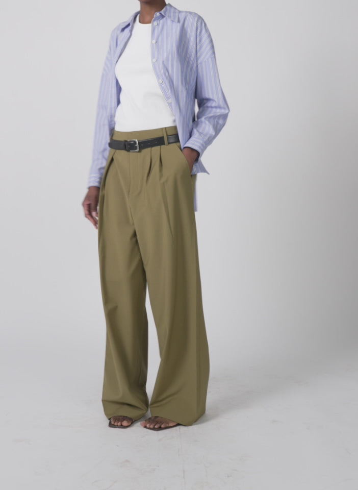 Model wearing the tropical wool stella pant dark hazel walking forward and turning around