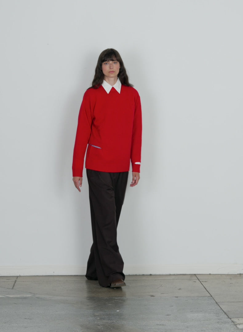 Model wearing the soft lambswool crewneck easy pullover red walking forward and turning around