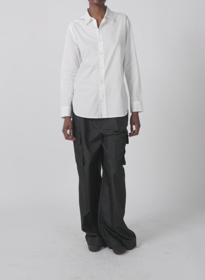 Model wearing the stella crispy nylon pleated cargo pant black walking forward and turning around