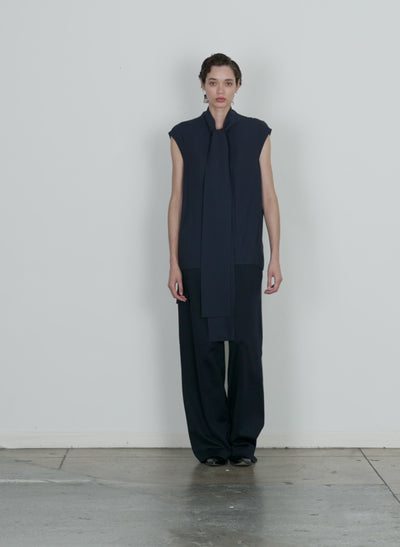 Model wearing the feather weight eco crepe sleeveless davenport scul midnight navy walking forward and turning around