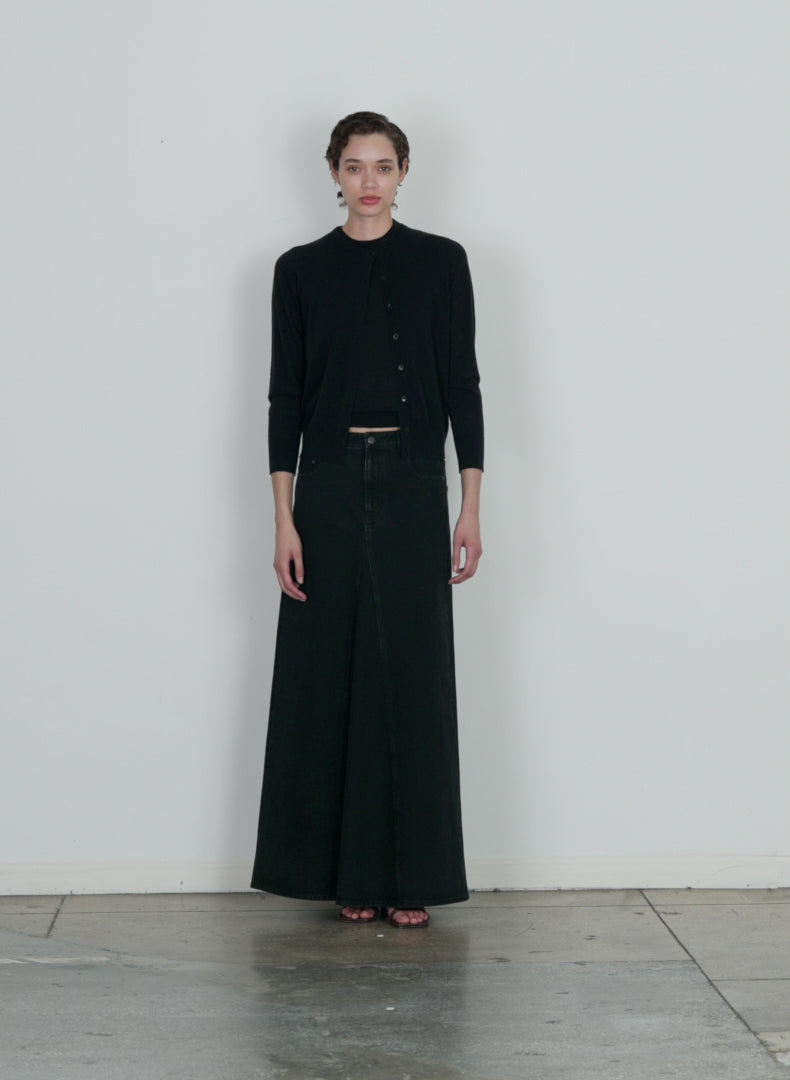 Model wearing the black denim godet maxi skirt black walking forward and turning around