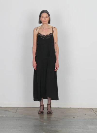 Model wearing the lace slip dress black walking forward and turning around