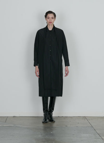 Model wearing the italian sporty nylon davenport shirtdress black walking forward and turning around