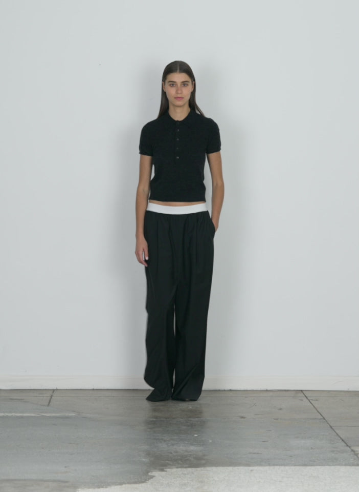 Model wearing the tropical wool marit pull on pant black walking forward and turning around