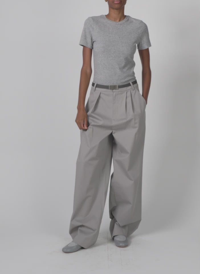 Model wearing the oliver cotton stretch tricotine stella pant grey moon walking forward and turning around