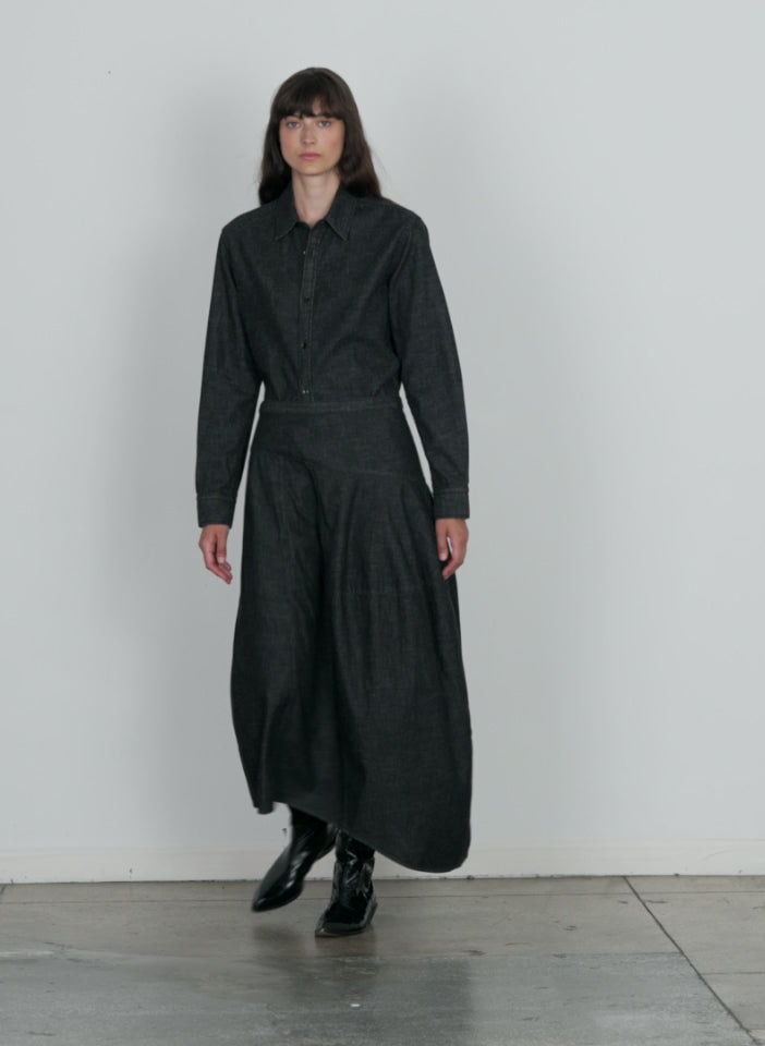 Model wearing the light weight stone washed black denim asymmetrical black walking forward and turning around