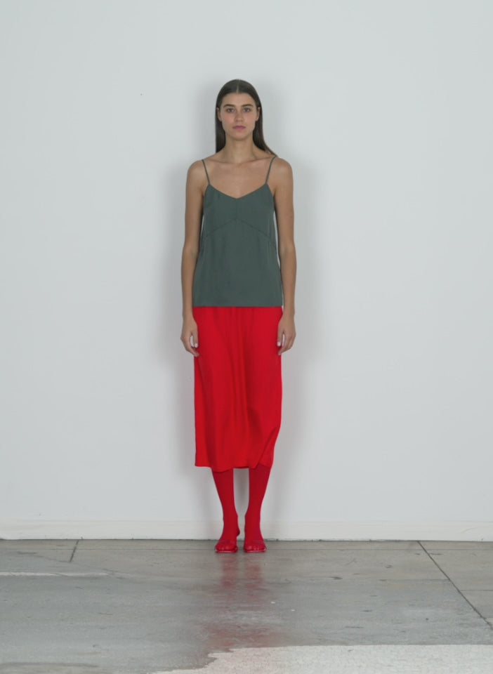 Model wearing the slip skirt red walking forward and turning around