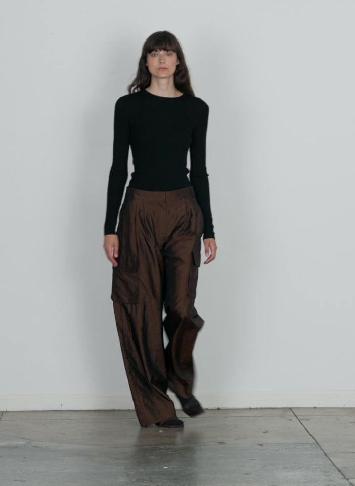 Model wearing the crispy nylon stella pleated cargo pant brown walking forward and turning around