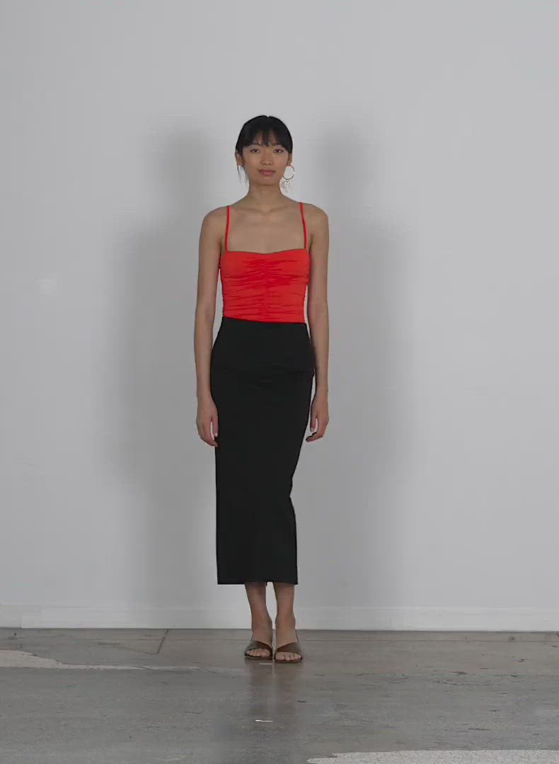 Model wearing the structured knit pencil skirt walking forward and turning around