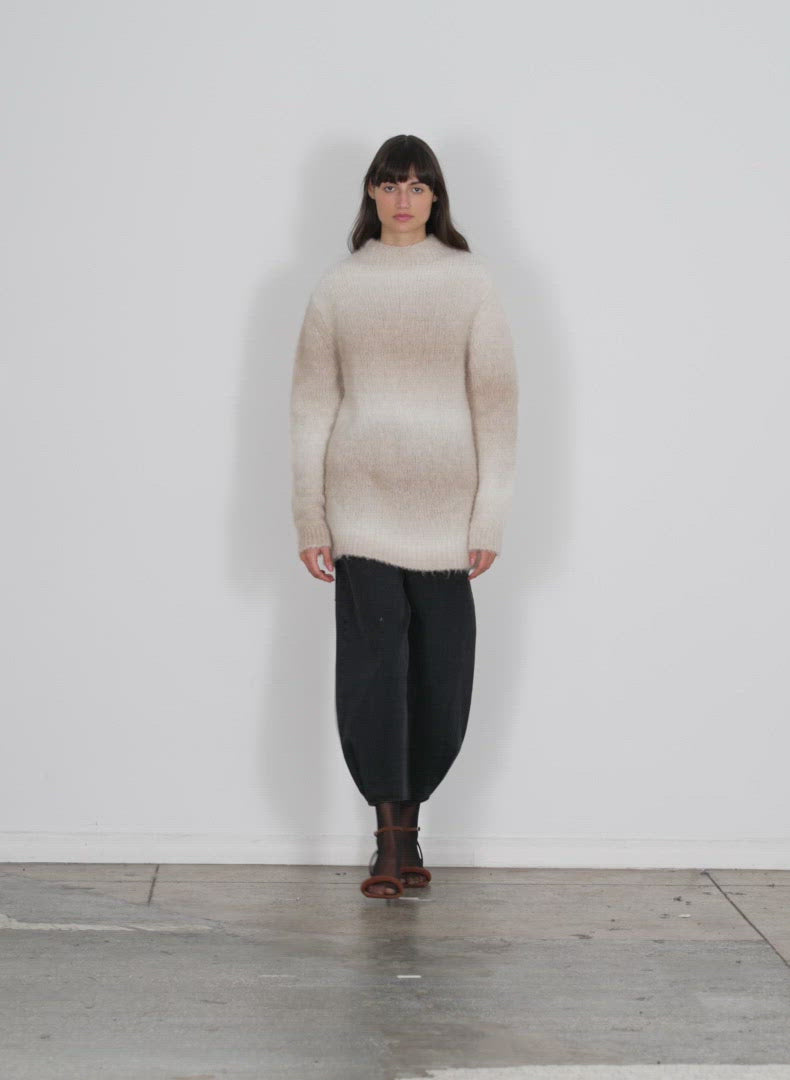 Model wearing the ombre superfine alpaca funnel neck pullover winter white multi walking forward and turning around
