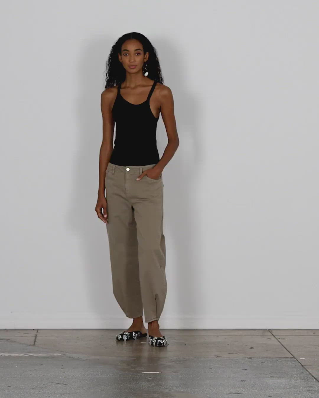 Model wearing the cotton drill long brancusi pant walking forward and turning around