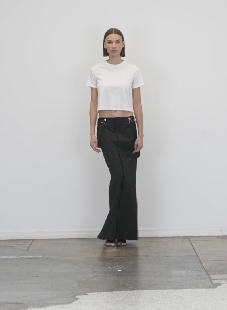 Model wearing the tshirting cropped t white walking forward and turning around