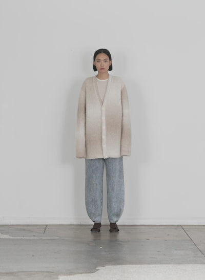 Model wearing the ombre superfine alpaca grandpa cardigan winter white multi walking forward and turning around