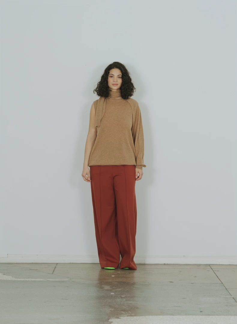 Model wearing the feather weight cashmere easy cozy cocoon tunic pul sand walking forward and turning around