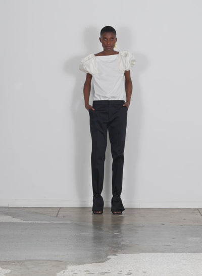 Model wearing the eco poplin boatneck box sleeve top white walking forward and turning around