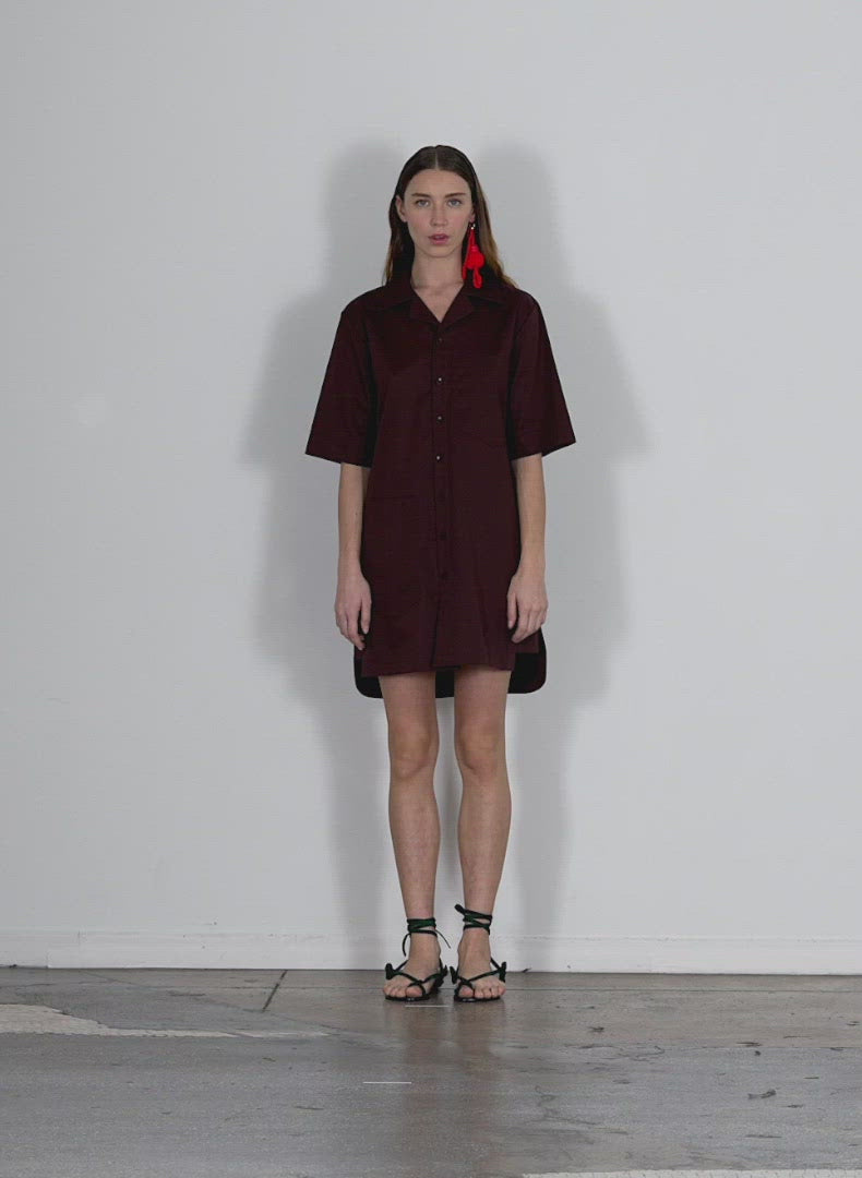 Model wearing the eco poplin camp dress brown walking forward and turning around