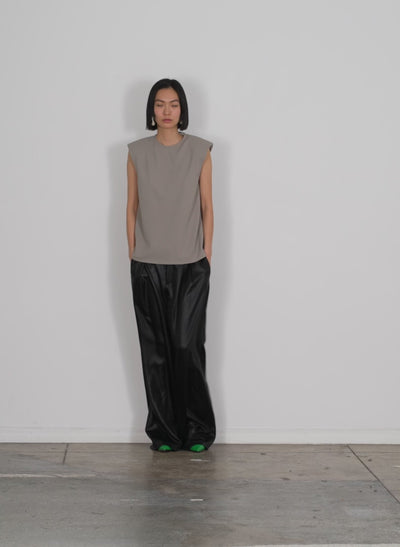 Model wearing the celia drape stella pant black walking forward and turning around