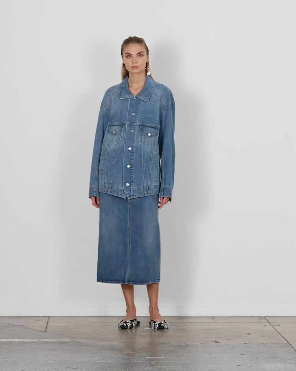 Model wearing the classic wash oversized jean jacket walking forward and turning around