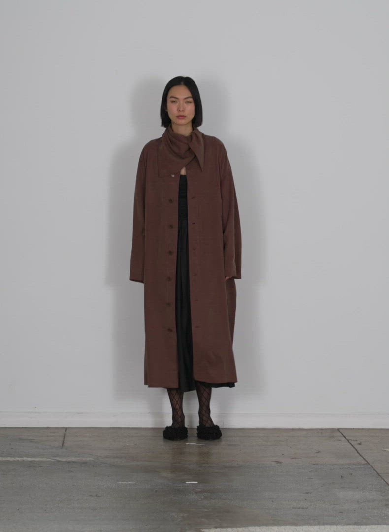 Model wearing the lancaster lyocell oversized fluid labcoat brown walking forward and turning around