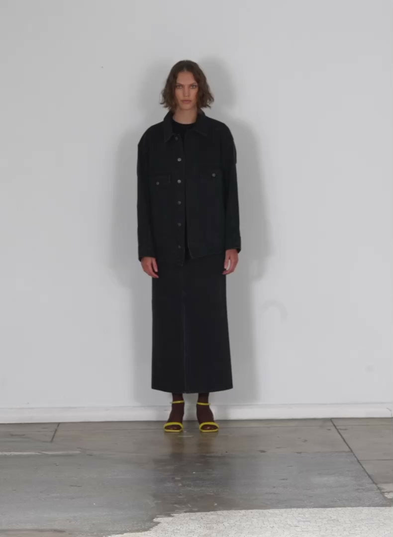 Model wearing the black denim oversized jean jacket black walking forward and turning around