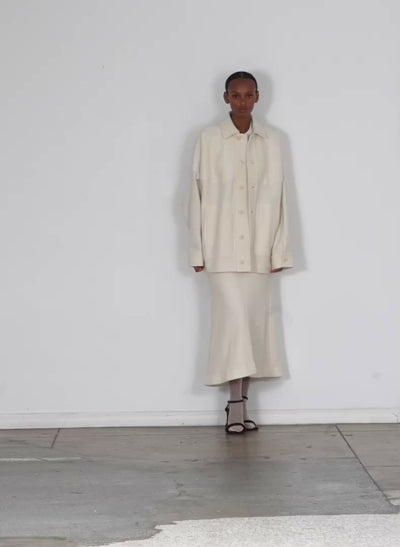 Model wearing the boiled wool oversized western shirt jacket ivory walking forward and turning around